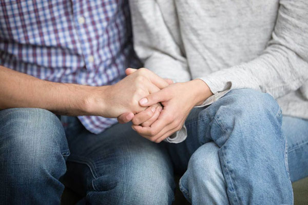 Consulting Couple Holding Hands